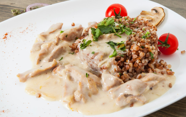 Beef Stroganoff. Beef with sour cream and garnish of buckwheat.