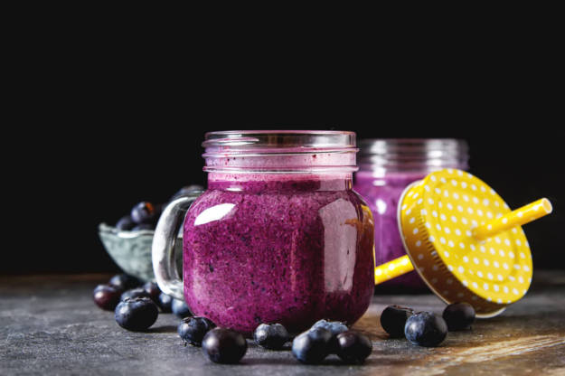 Fresh juicy blueberry smoothies in the glass. Simple background. Healthy food. Detox. Lifestyle.