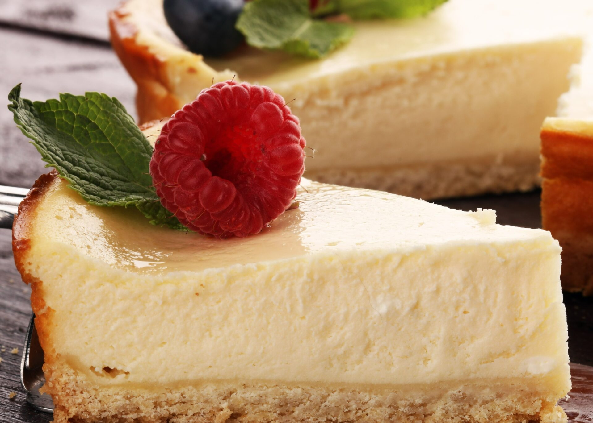 Homemade cheesecake with fresh raspberries and mint for dessert - healthy organic summer dessert pie cheesecake. Vanilla Cheese Cake.