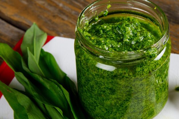 Fresh homemade wild garlic pesto. Home made sauce made with wild garlic, pine nuts, cheese and olive oil.
