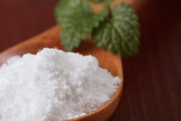 Icing sugar in a wooden spoon